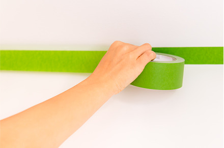Applaying masking tape to the wall, an Architecture Photo by MAnuta