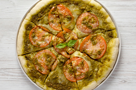 Homemade Pesto Pizza with Fresh Tomatoes and Mozzarella on a whi, a Food & Drink Photo by LiudmylaChuhunova