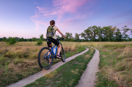 Woman riding a mountain bike in cross country road in summer, a Sports & Recreation Photo by den-belitsky