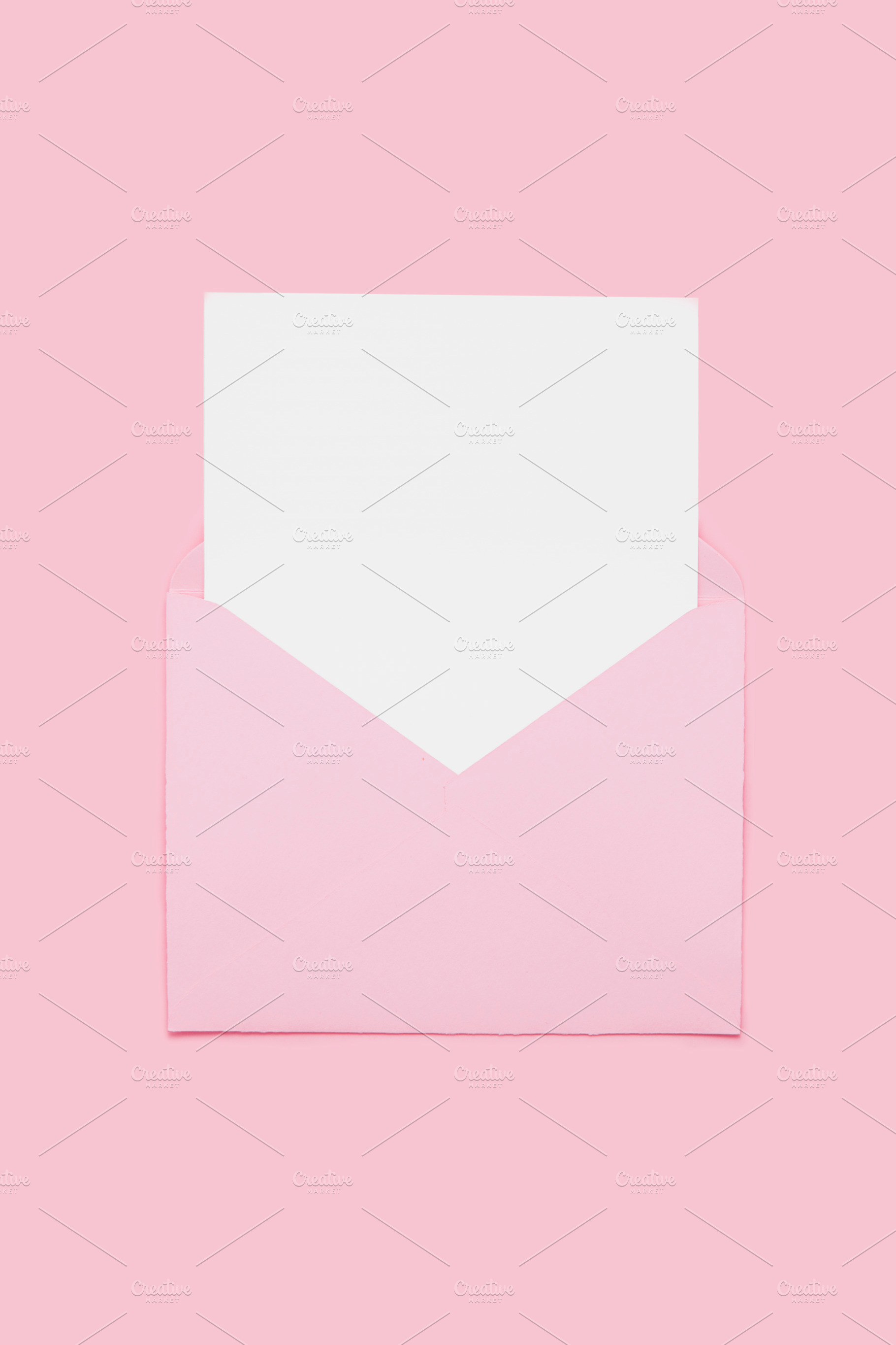 Blank empty white paper card in pink opened envelope isolated on pink backgroun, an Abstract Photo by Lenor4ik