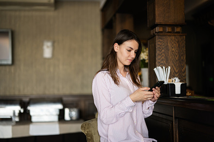 Young beautiful brunette woman sitting near bar counter, waiting, a Person Photo by AS photostudio