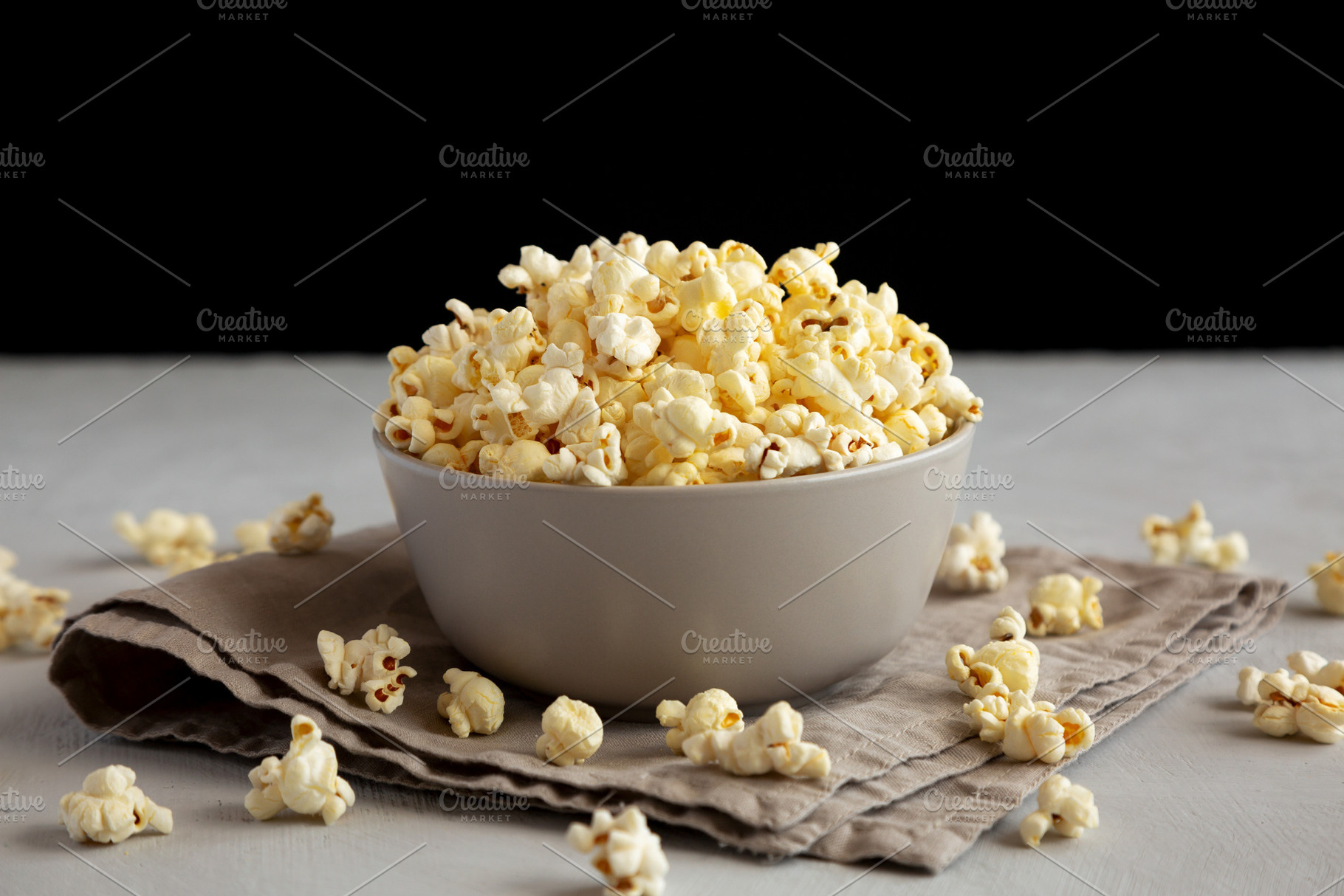 Homemade Salty Popcorn in a Bowl, side view., a Food & Drink Photo by LiudmylaChuhunova
