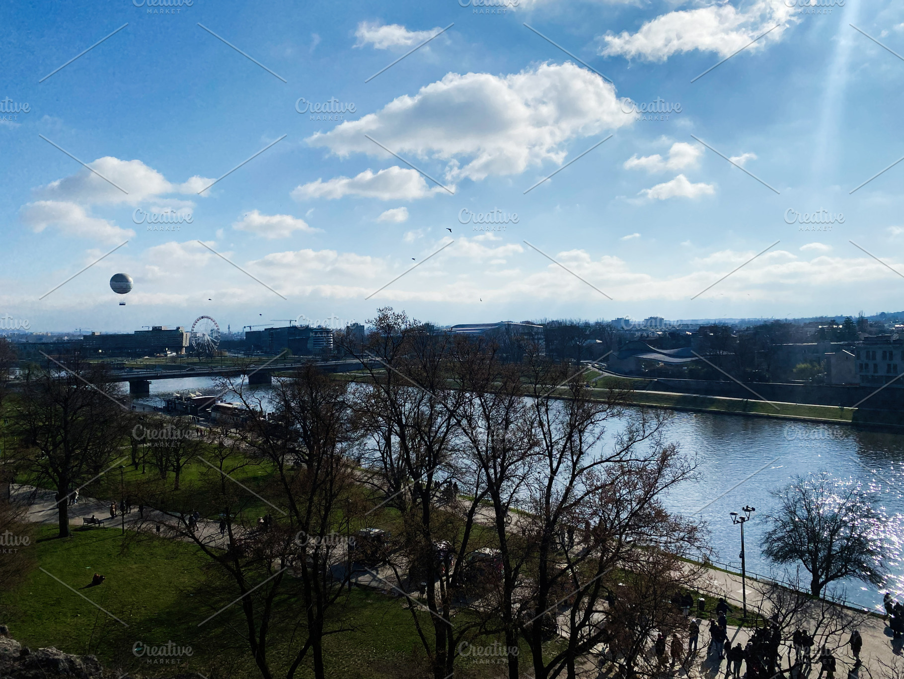Scenic view of Krakow riverside with blue sky and trees in Europe, a Photo by AS photostudio