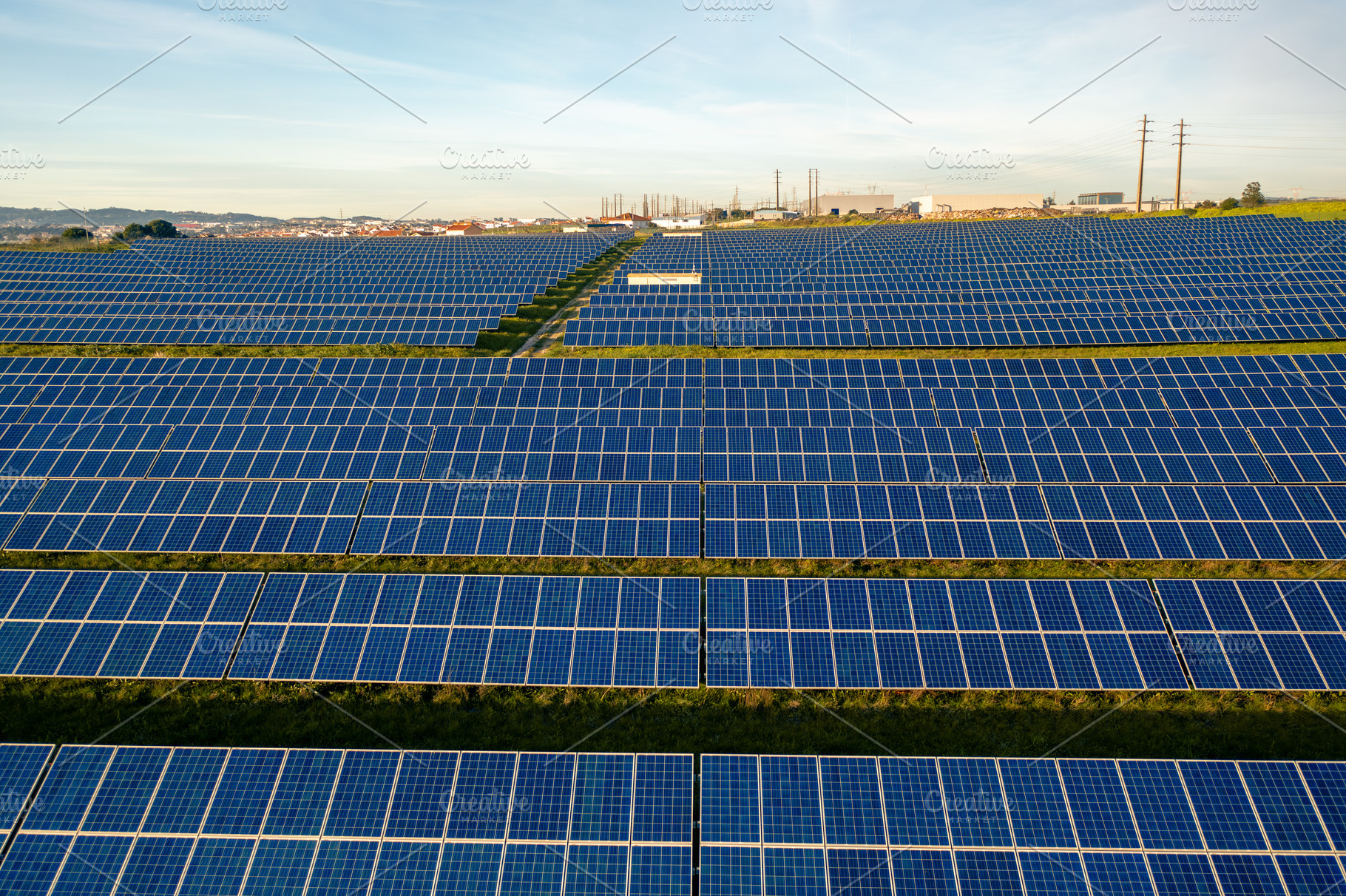 Drone view of blue solar panels on agricultural land during sunny day, a Photo by andreonegin market