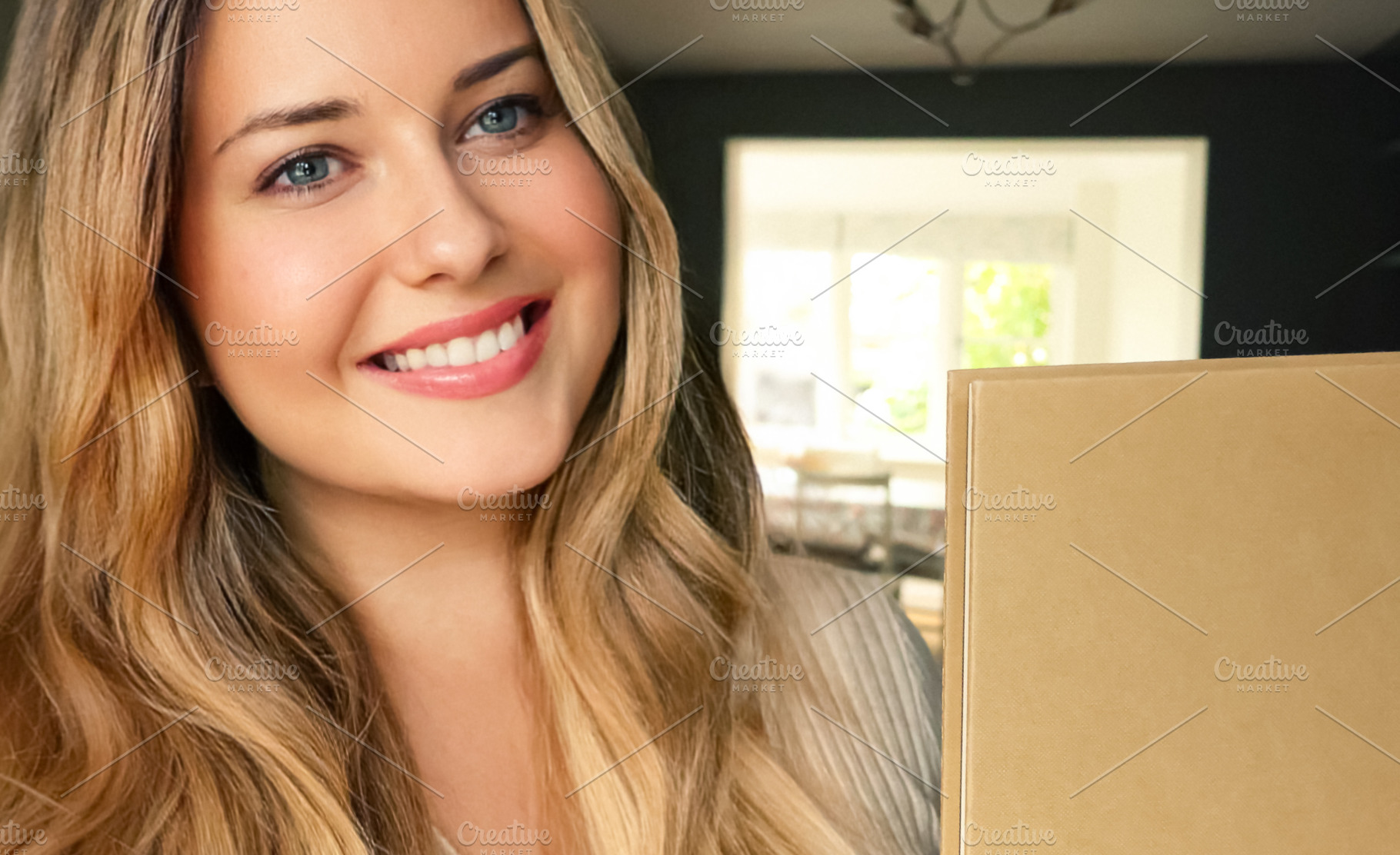 Young woman smiling, holding an unboxing parcel or happy gift bo, a Person Photo by Studio ANNA