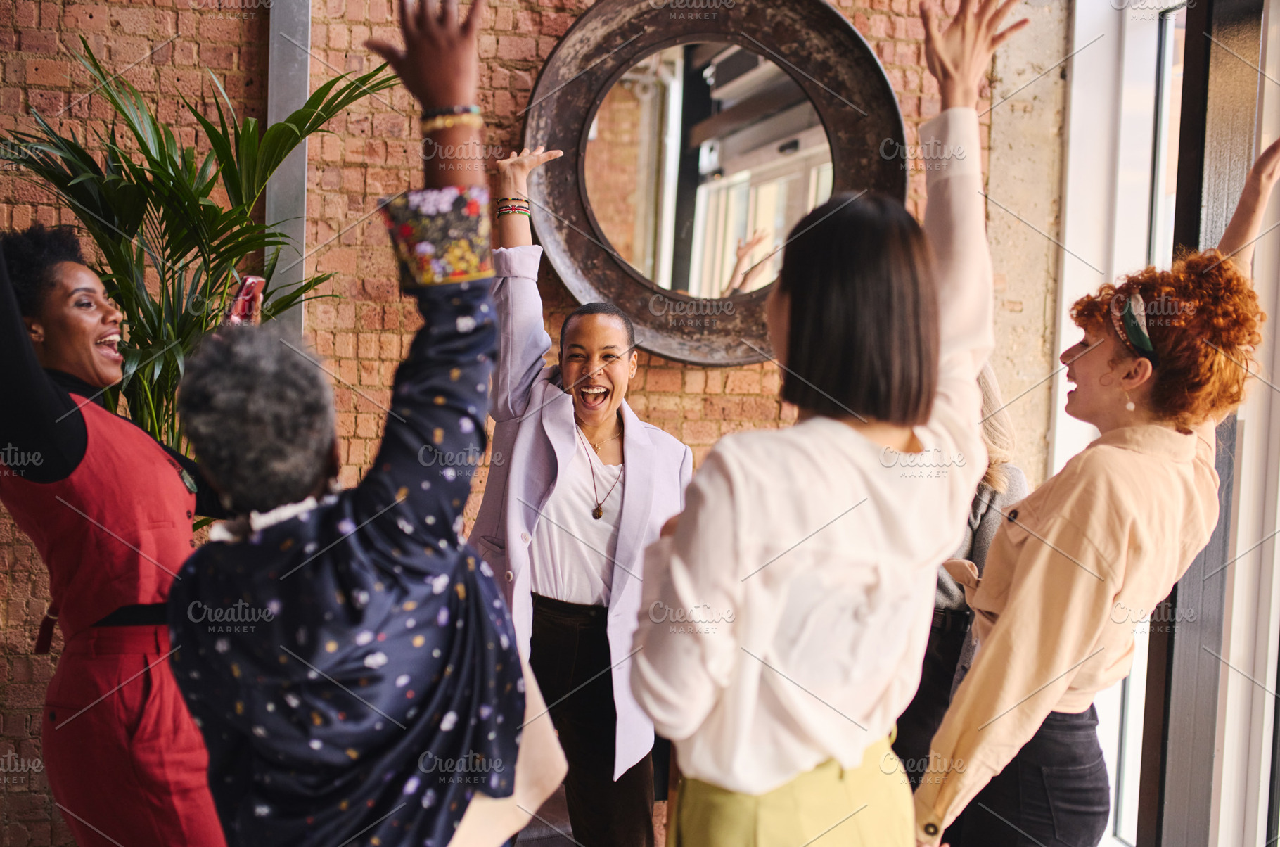 Multi ethnic mixed age range businesswomen cheering in support of International, a Technology Photo by Southworks