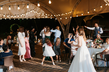 bride in a white dress throws a wedding bouquet