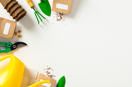 Gardening tools, peat pots, seeds packets, watering can on white background. Sp, a Holiday Photo by photoguns