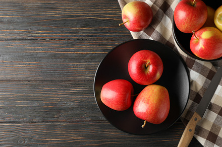 Composition with apples, plate and kitchen towel on wooden backg, a Food & Drink Photo by AtlasStudio