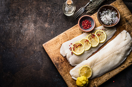 Raw cod fish fillet with lemon, a Food & Drink Photo by VICUSCHKA