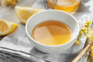 Natural linden honey in bowl with fresh lemon, a Food & Drink Photo by Olena Rudo
