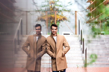 Portrait of stylish handsome young man with coat standing outdoo, a Person Photo by RF Images