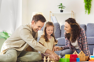 Family Building Toy Houses on Floor, a Person Photo by StudioRomantic
