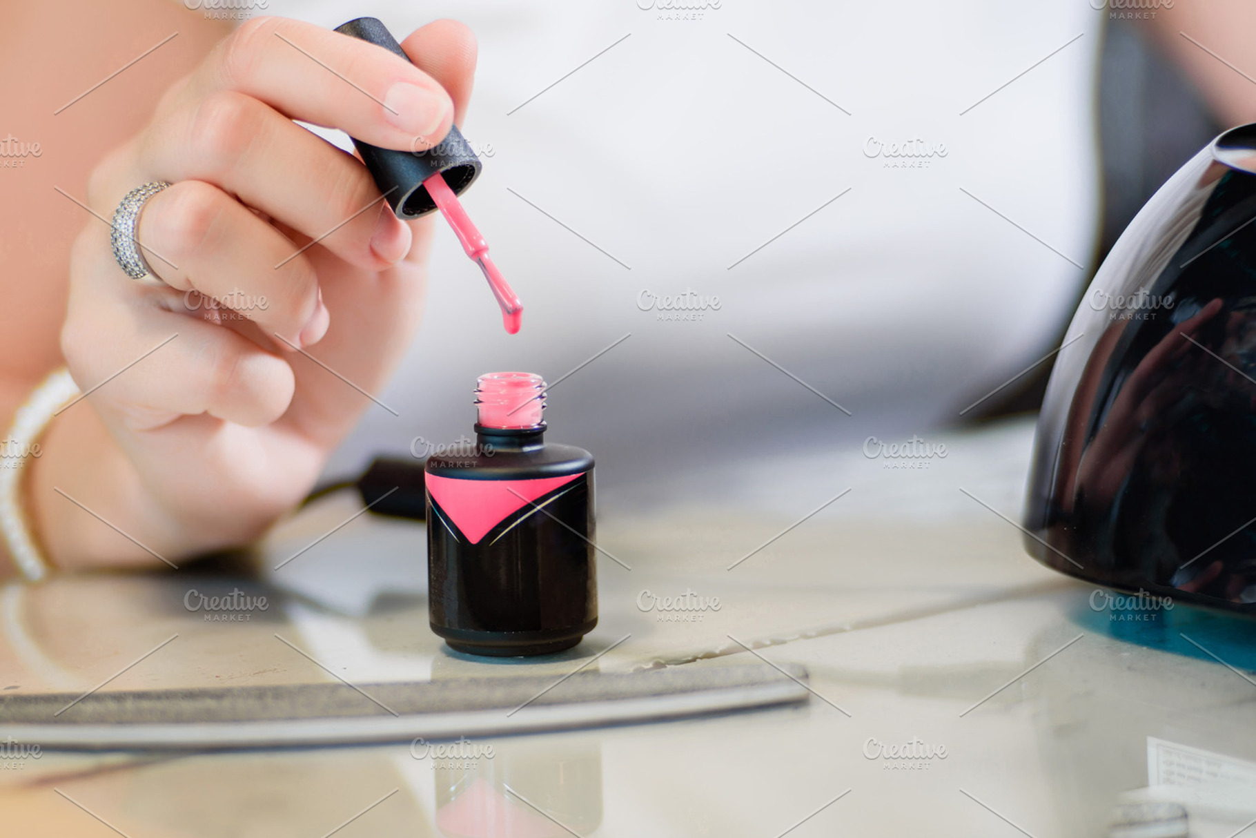 Pink gel nails polish containing nail, manicure, and female, a Person Photo by BodiaPhoto