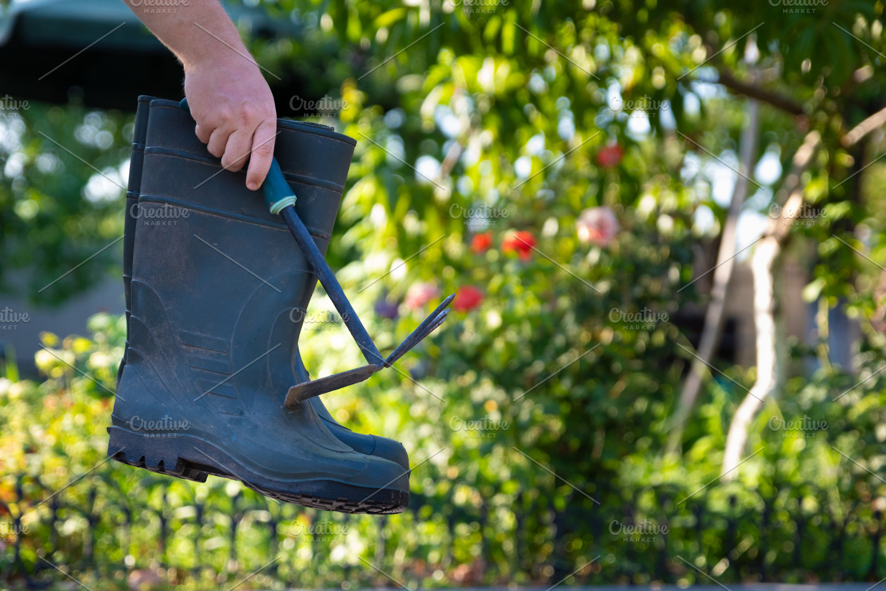 Hand Holding Garden Boot and Tool, a Nature Photo by Ales Munt