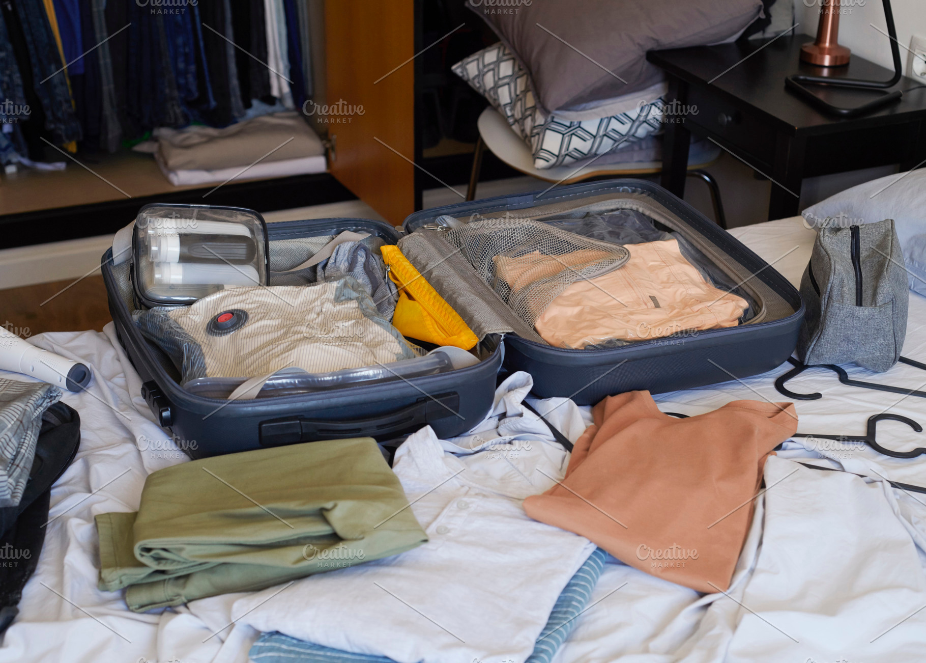 an open suitcase organized with travel clothes, a Photo by Nito
