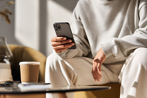 Person using smartphone in a cafe, a Photo by Beautiful things