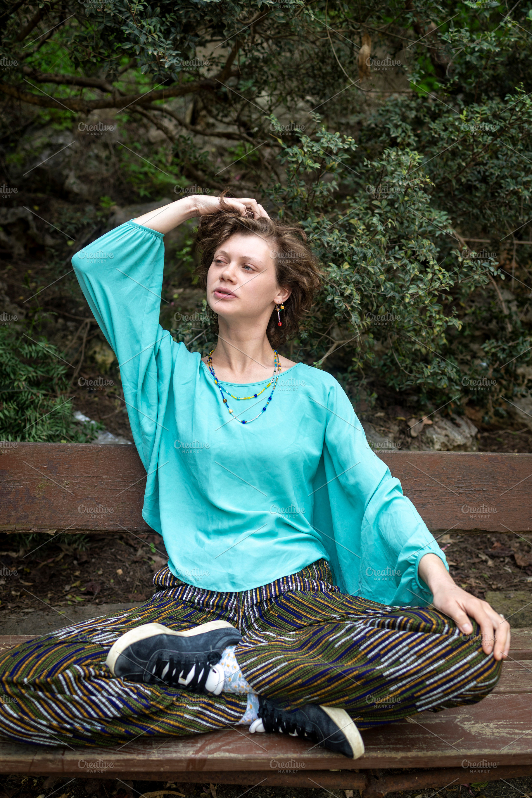 A young woman with curly hair sittin, a Person Photo by Imaginarium