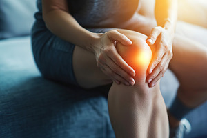 Man with glowing knee pain, a Health & Medical Photo by AlyaAnd