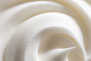 Whipped cream swirl forming a soft, creamy texture, creating a d, a Photo by Studio ANNA