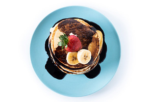 Pancakes with chocolate and fruit isolated on white background, a Food & Drink Photo by etorres69