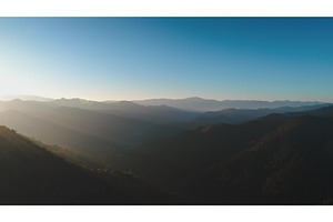 Sun shining over misty mountain, a Nature Photo by Goinyk