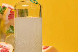 Fresh citrus drink with lemon, grapefruit, and mint in a glass w, a Food & Drink Photo by ndanko