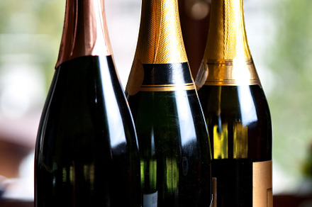 Bottles of champagne on a table. High quality photo., a Food & Drink Photo by FoodStock