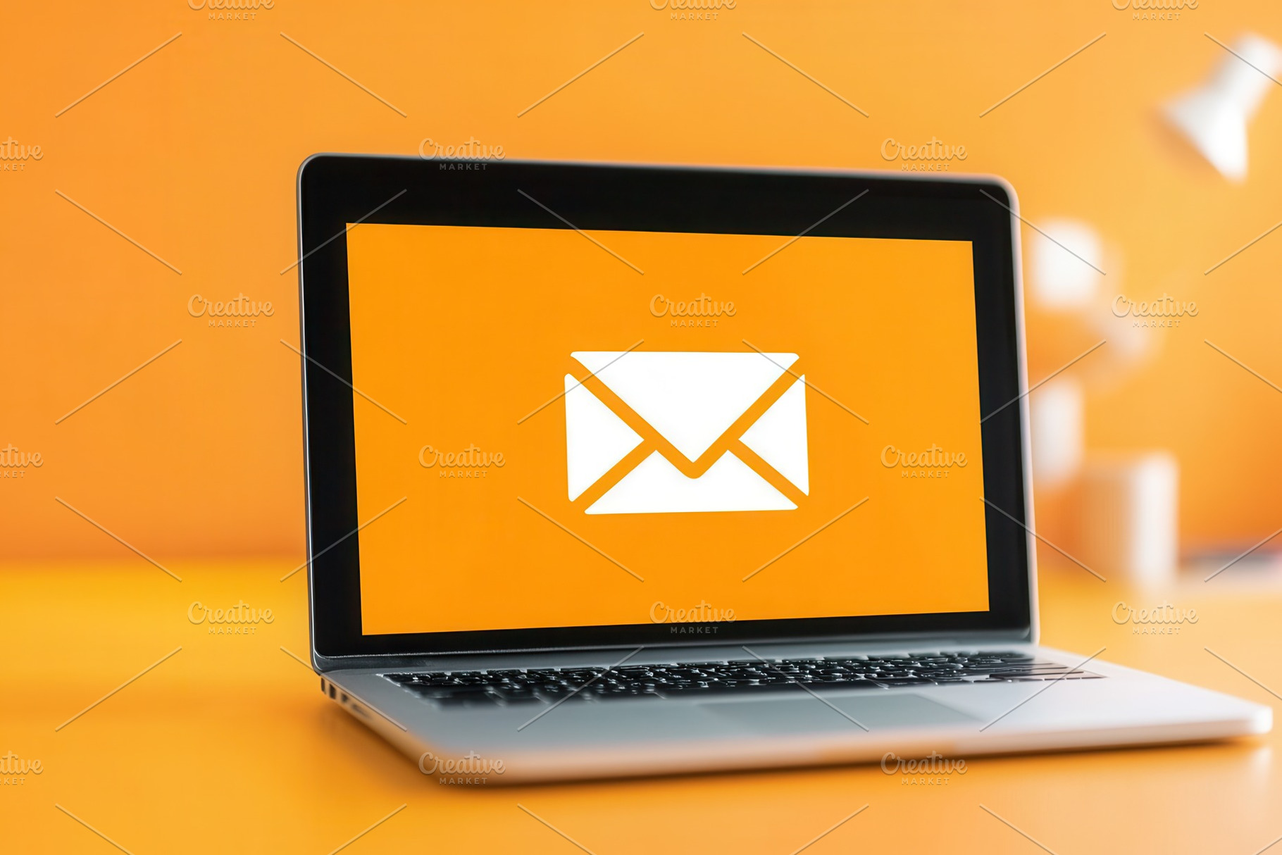 Laptop displays vibrant mail icon, a Photo by Pavel_design