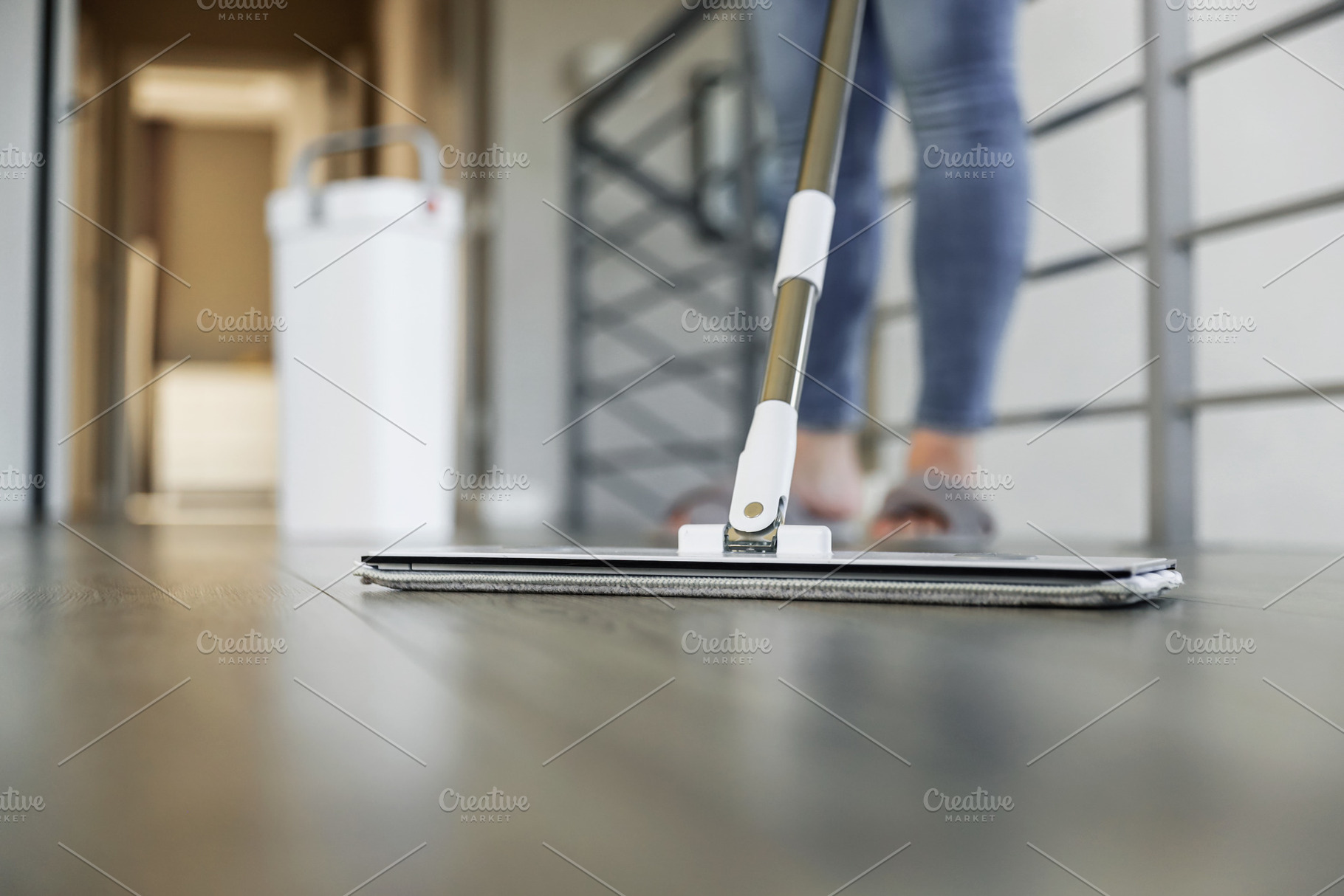 Woman mopping, wiping floor in modern home setting, a Person Photo by Lenor4ik