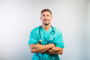 Happy Male Nurse or Doctor in Scrubs, a Person Photo by karrastock