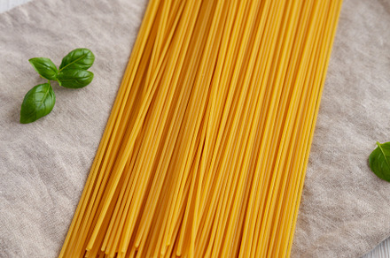 Raw Organic Spaghetti Pasta in a Bunch, low angle view., a Food & Drink Photo by LiudmylaChuhunova