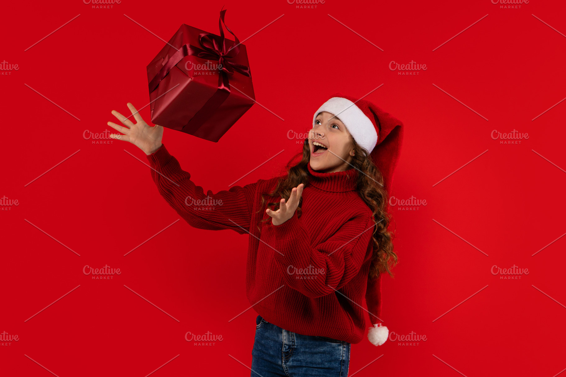 Excited girl in Santa hat, a Holiday Photo by Elena Vagengeim