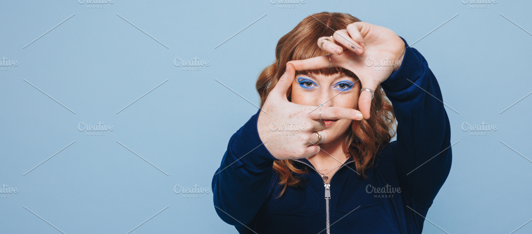 Woman making a finger frame in a studio, a Person Photo by Jacob Lund