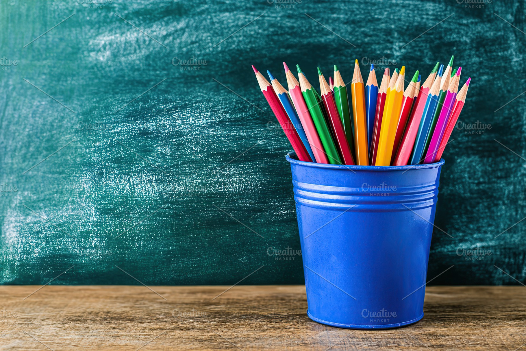 Wooden colorful rainbow pencils in bucket on wooden table, a Photo by AlyaAnd