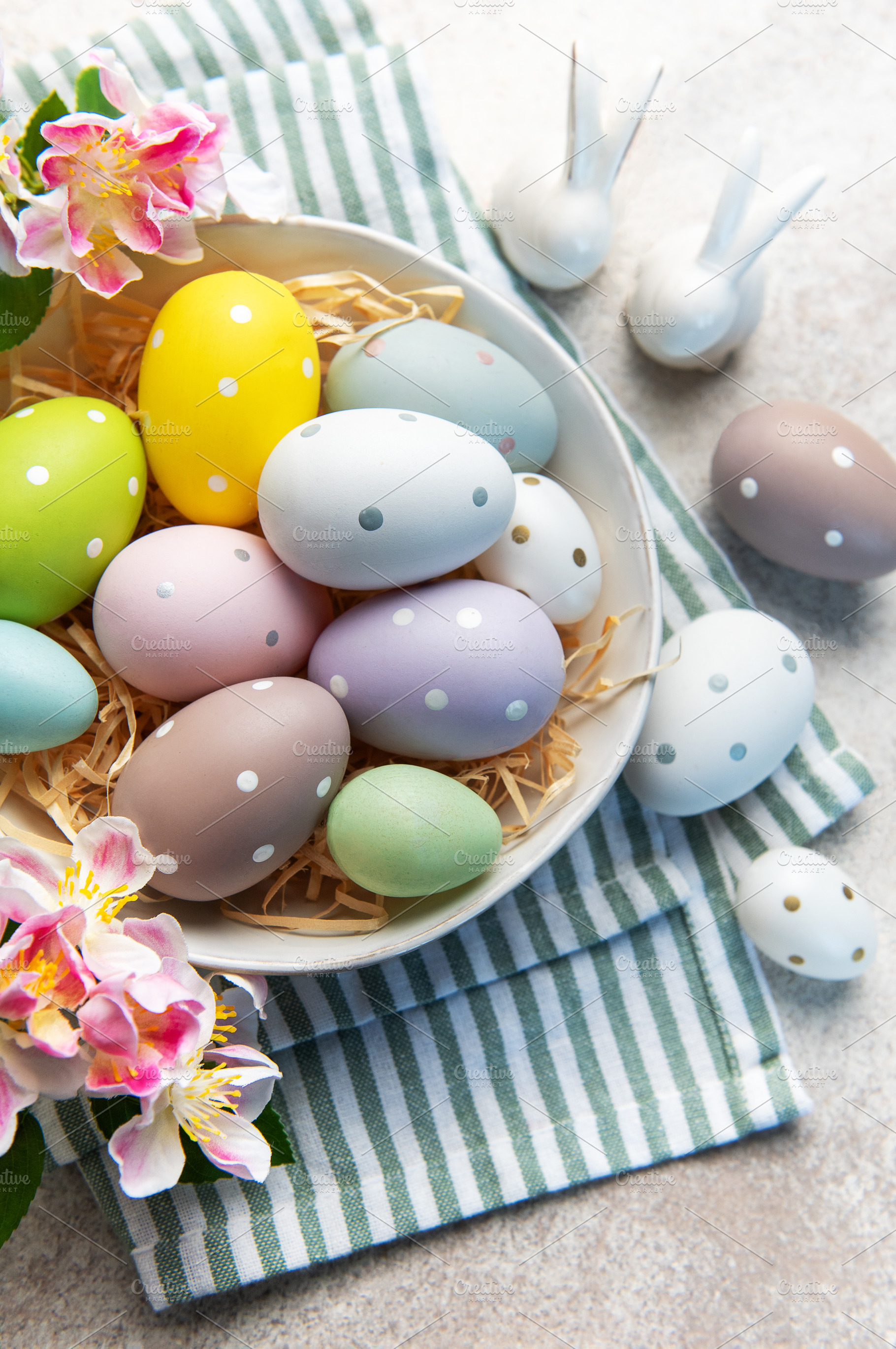 Pastel easter eggs in a bowl with spring flowers, a Holiday Photo by Olena Rudo