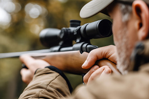 Close up of a hunter aiming a scoped, a Sports & Recreation Photo by MistyDay