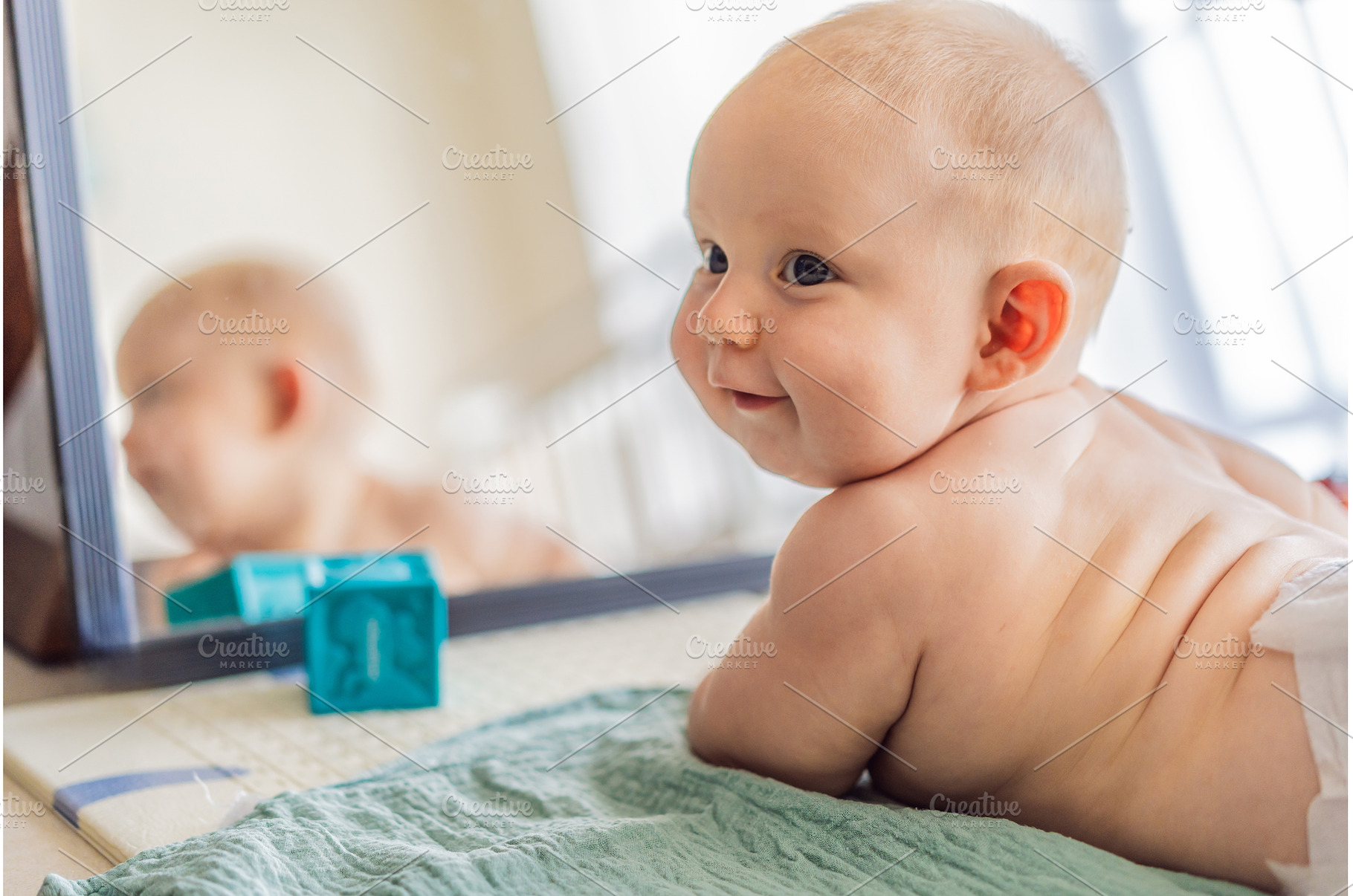 Baby lying on play mat learning to, a School & Education Photo by Elizaveta Galitskaya