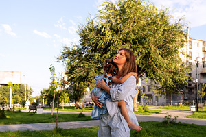 Mother gazes upward while cradling, a Person Photo by Elena Vagengeim