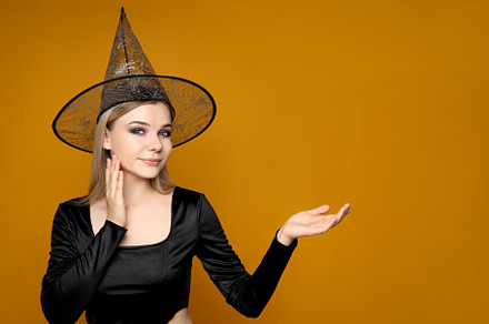 Concept of Halloween, young woman on yellow background, a Person Photo by AtlasStudio PRO