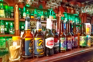 Beer selection at traditional bar counter, a Food & Drink Photo by DanFLCreativo