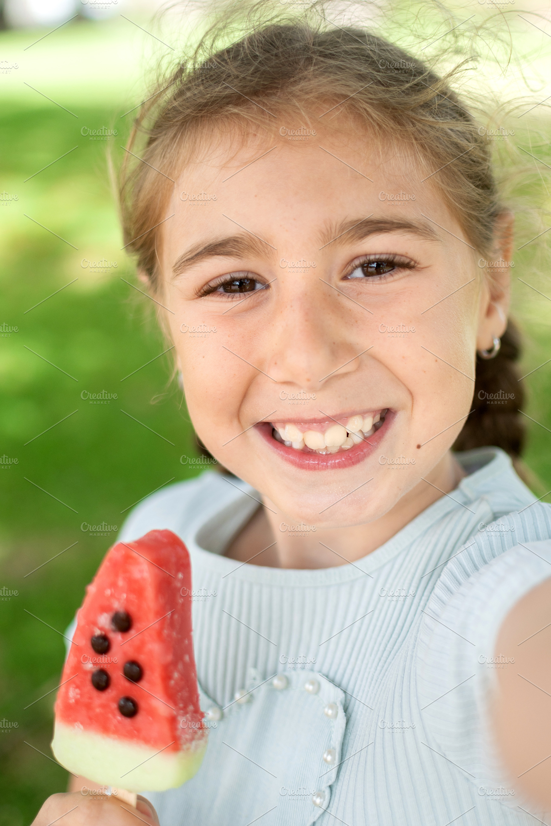 Happy Little Girl Taking a Selfie While Holding a Watermelon Popsicle, a Person Photo by etorres69