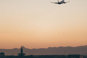 Jet over sea at sunset sky, a Transportation Photo by SkyNext