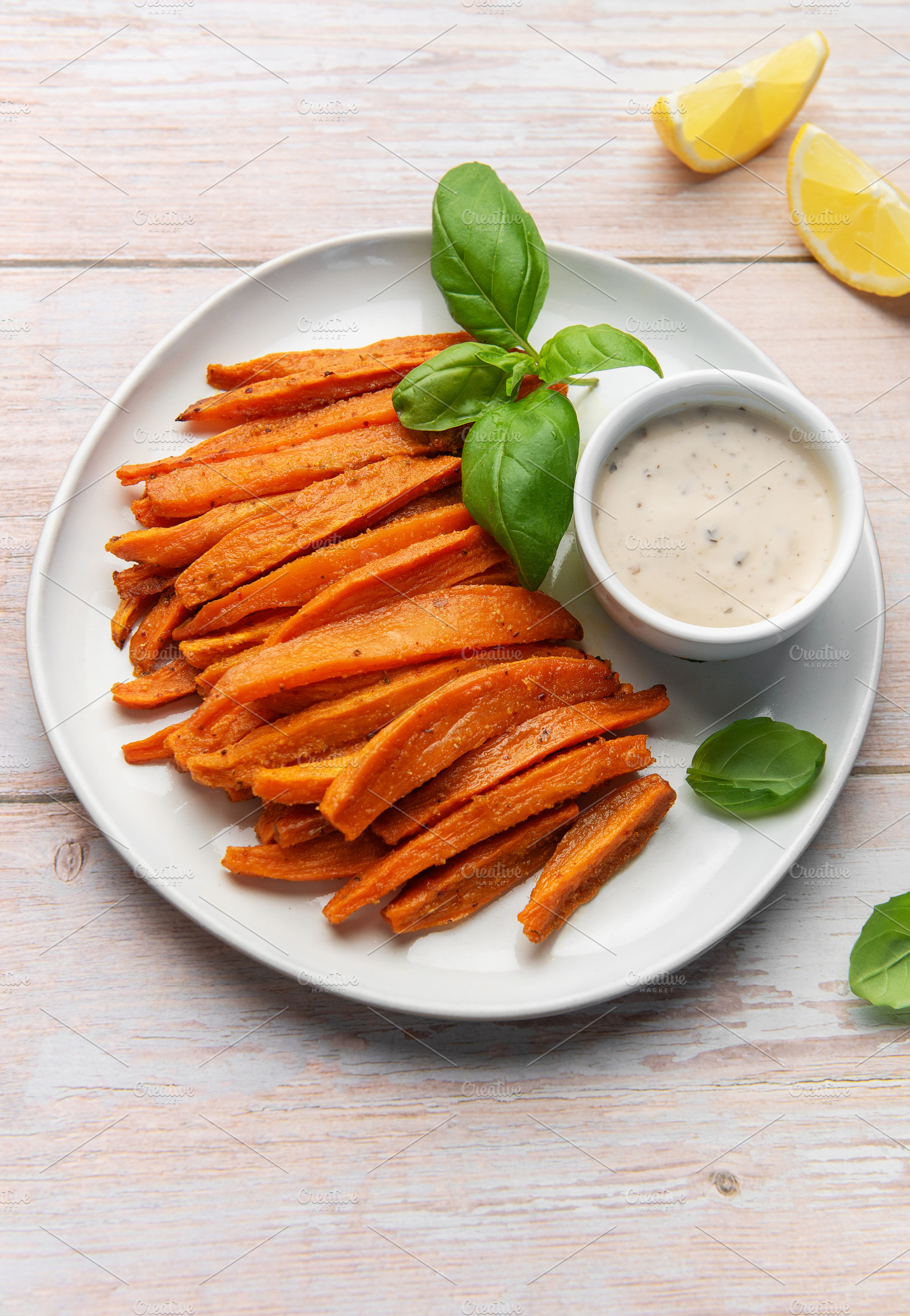 Sweet potato fries with dipping sauce and fresh basil, a Food & Drink Photo by Olena Rudo