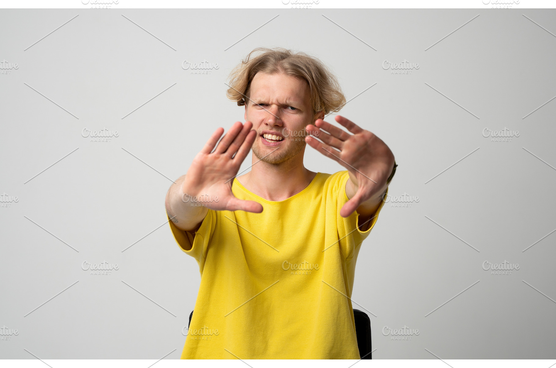 Young man showing a stop gesture, a Person Photo by volodymyrshtun13795