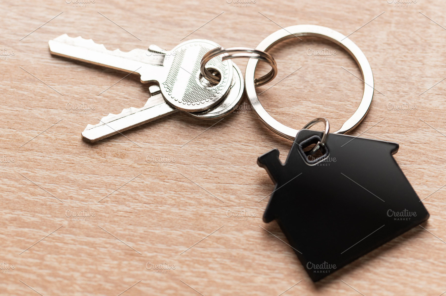 House keys with house shaped keychain on wood, a Business Photo by Olena Rudo