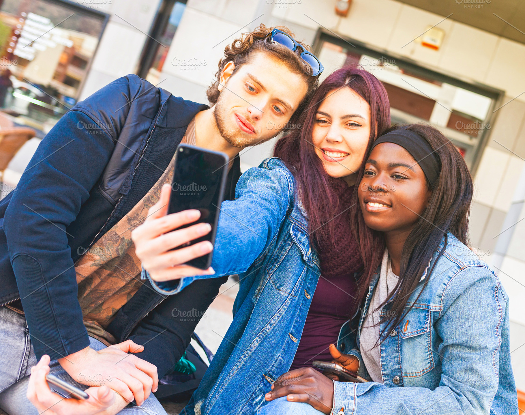 Group of multi ethnic friends taking selfie with smartphone outdoors, a Person Photo by Antonio Gravante Market