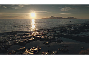 Golden sunset reflecting on wet, a Nature Photo by Goinyk