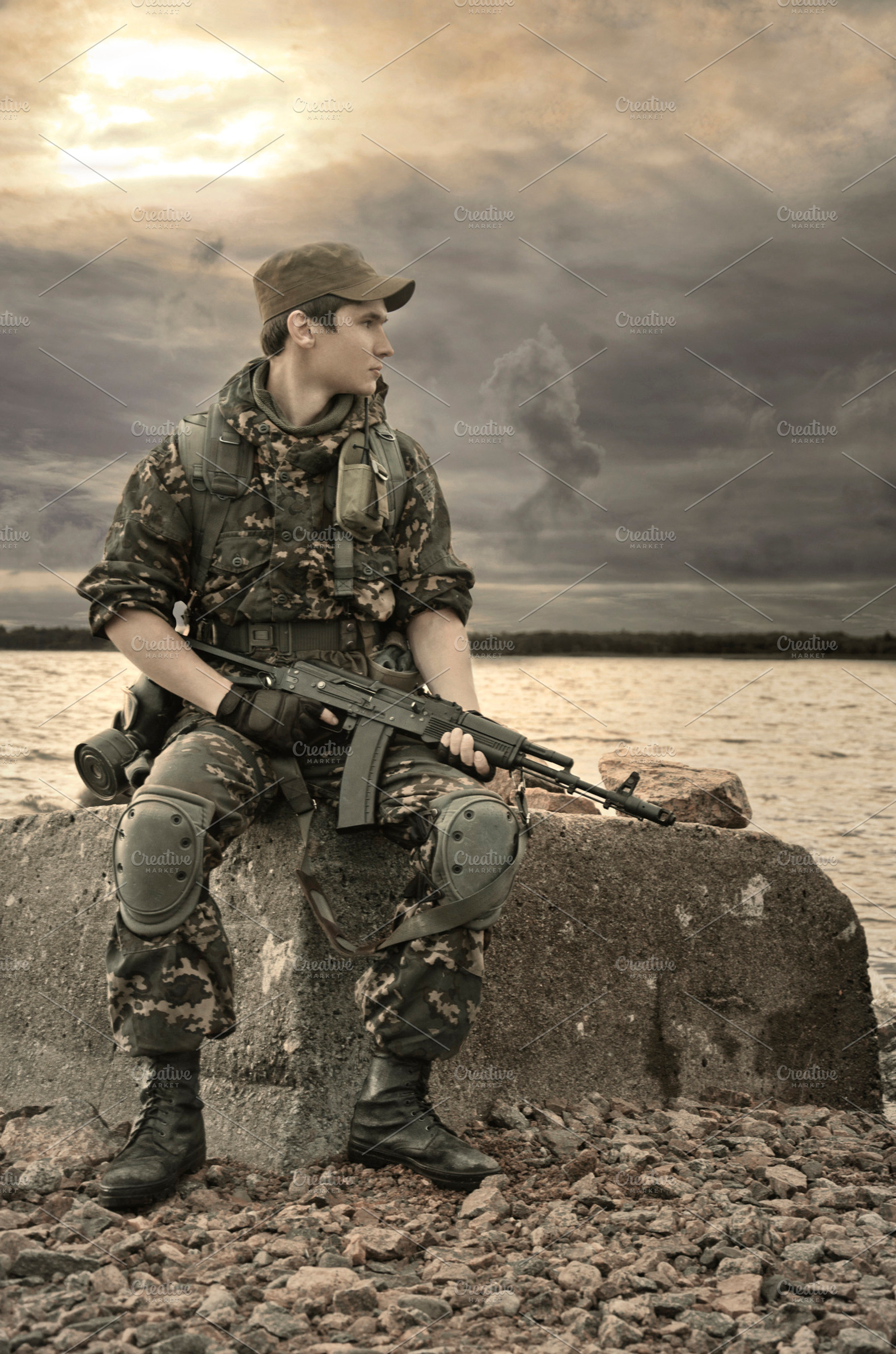 Man with gun featuring toned image, sunrise, and sunset, a Person Photo by Innire