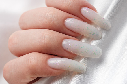 A woman's hands with a manicure on them, the nails are painted i, a Beauty & Fashion Photo by Olena Rudo